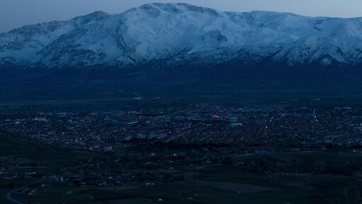 Evening view from the height of the city of Erzincan. Snowy Munzur mountains on the horizon