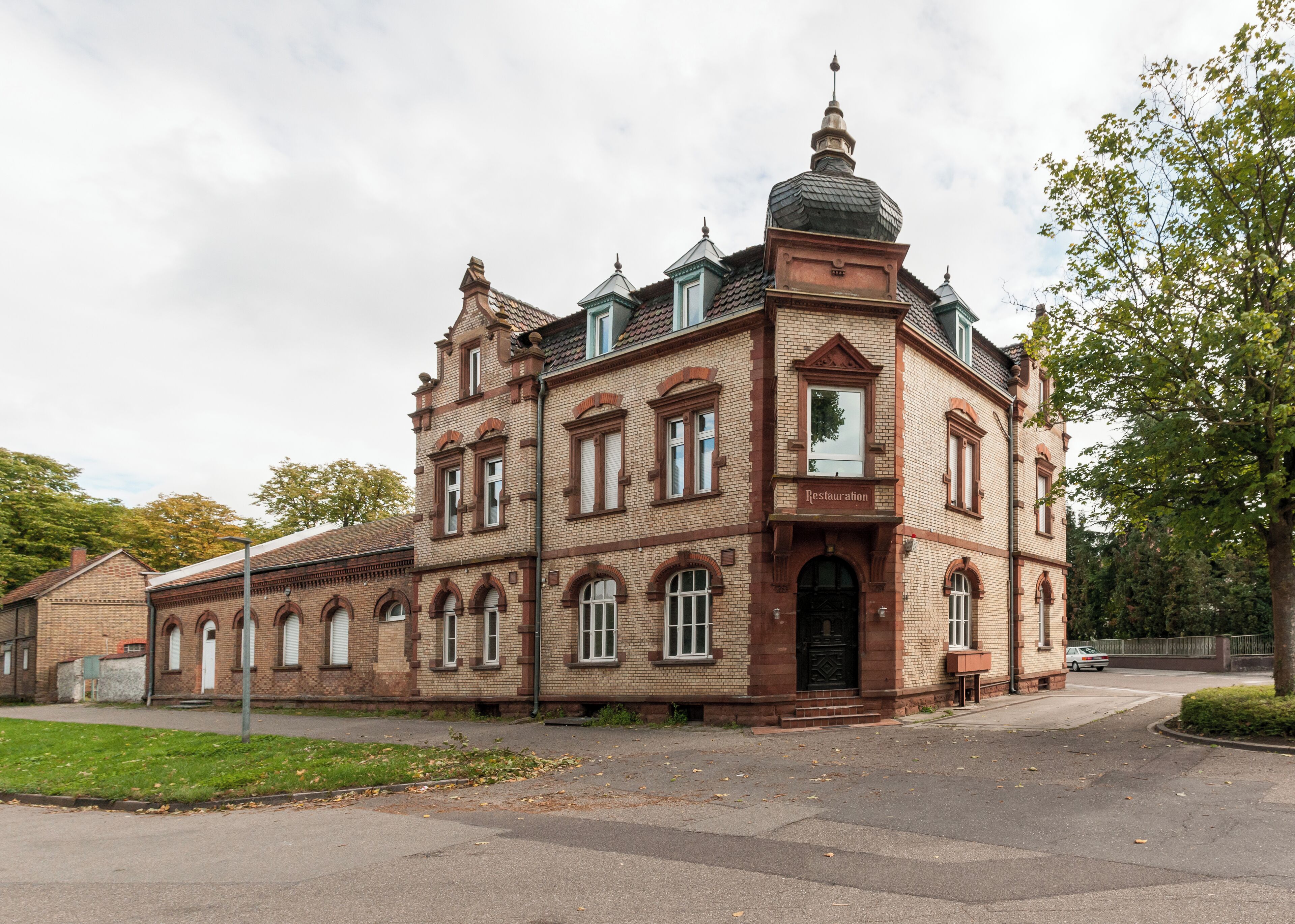 A historic brick building with a prominent dome and arched windows.