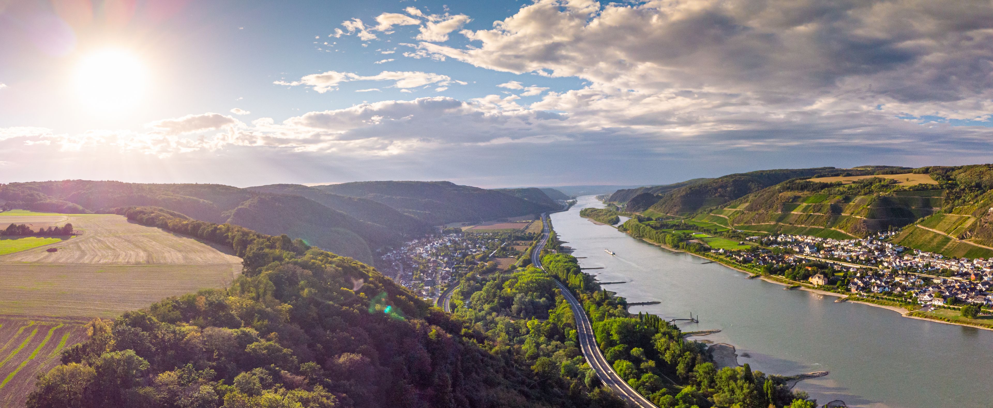 A river valley with a bridge, fields, and a town.