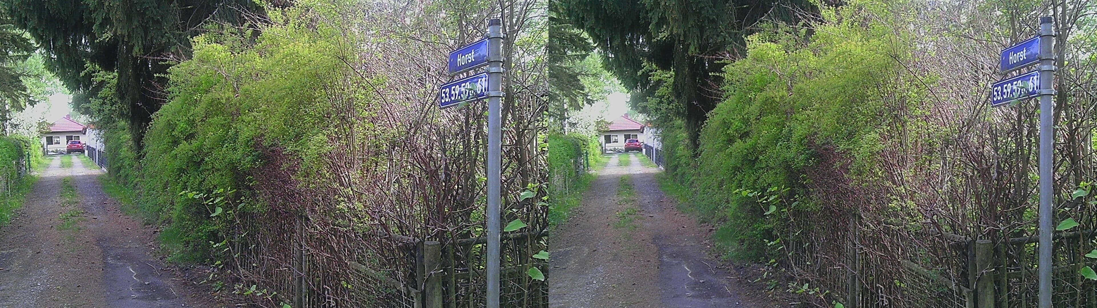 A road with signs indicating 'Hort' and coordinates '53.59.59.61'.
