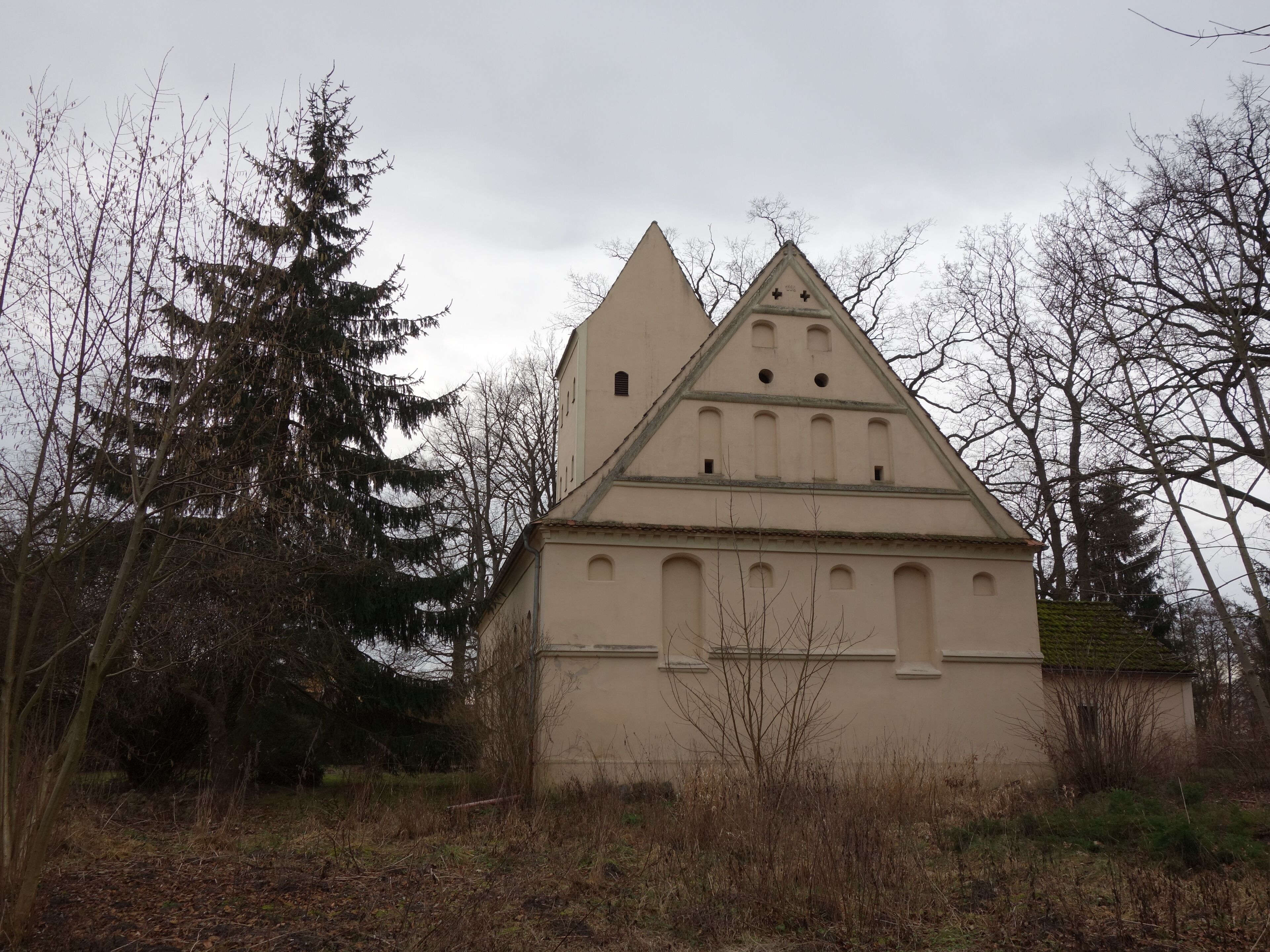 A church with a triangular roof and a bell tower.