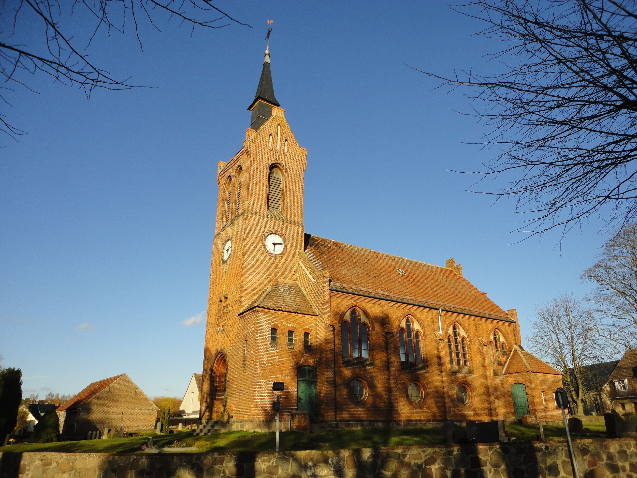 A church with a tall tower and a clock.