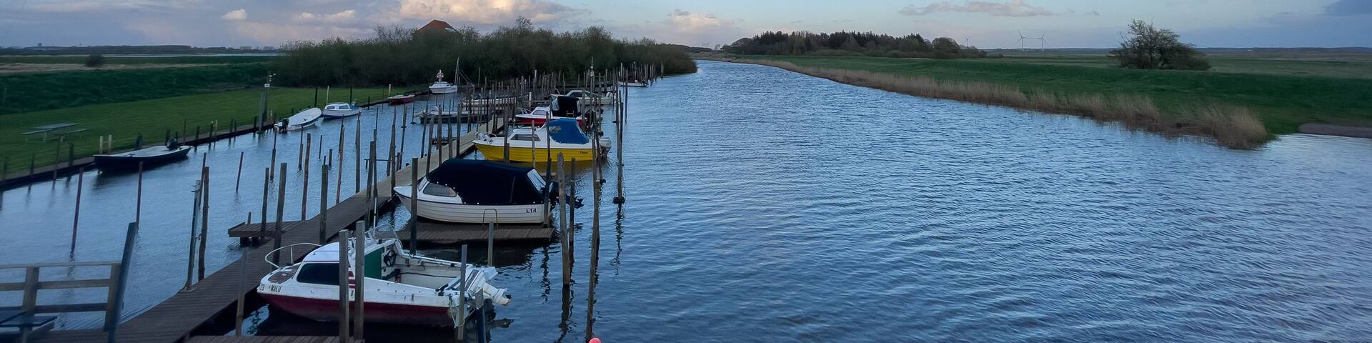 Evening light over a little dock in the river Vidå near the town of Aventoft in northern Schleswig-Holstein
