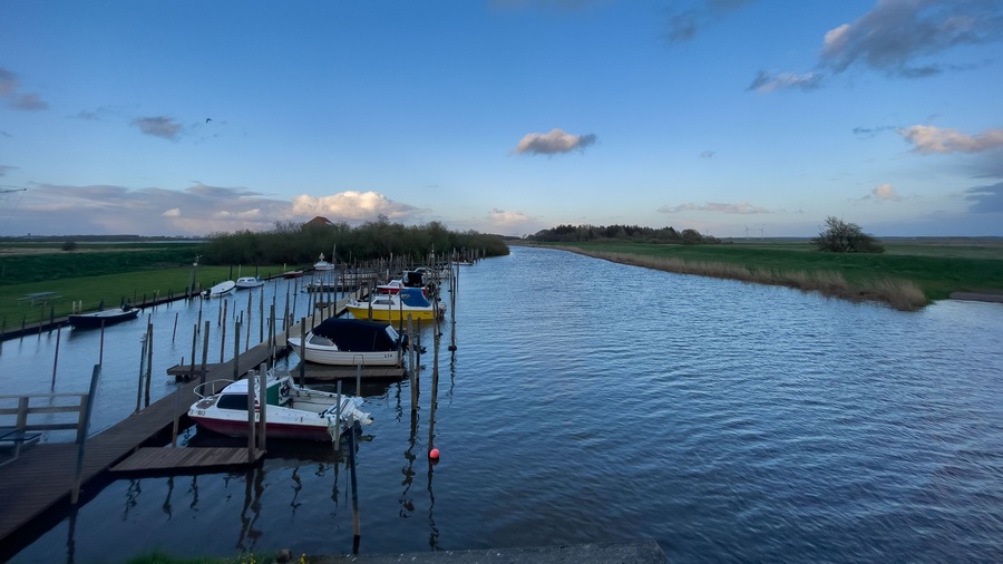 Evening light over a little dock in the river Vidå near the town of Aventoft in northern Schleswig-Holstein