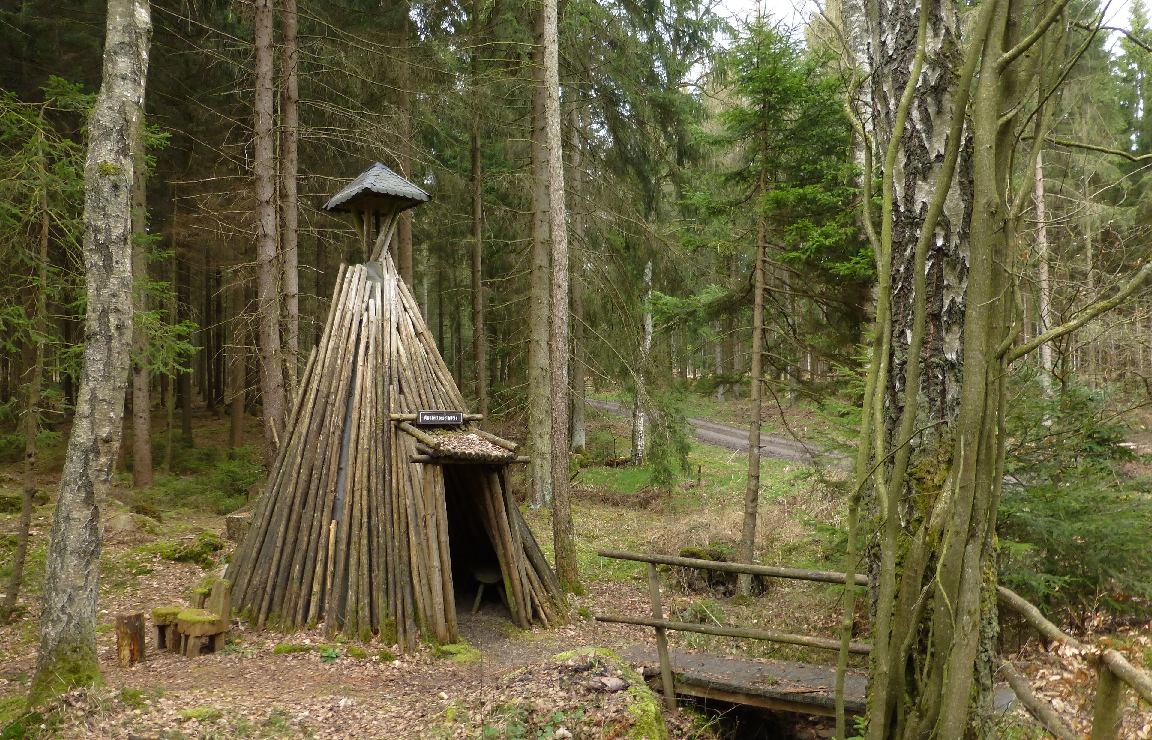 A wooden structure in a forest with a sign that reads "Appetizer."