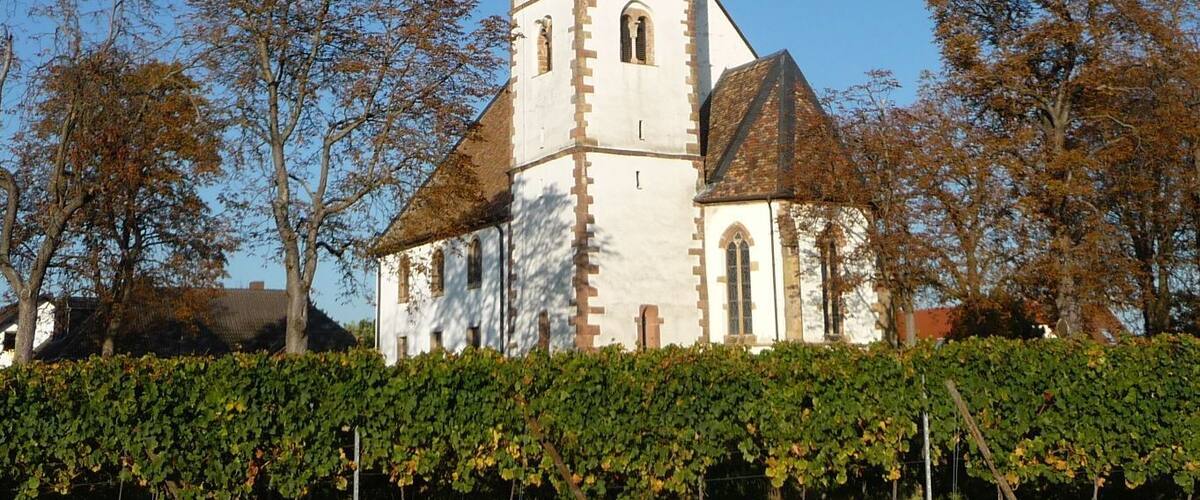 A church with a tall, pointed steeple and a clock tower.