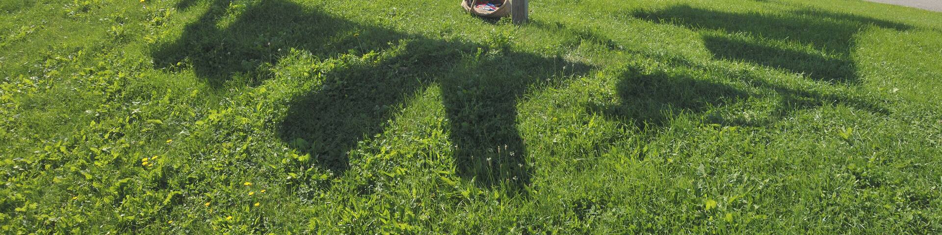 View from the Backenswarft on Hallig Hooge. The Hallig Hooge is the second largest of the ten islets in the Schleswig-Holstein Wadden Sea. She is surrounded by an approximately 1.20 meters high stone dyke and is thus protected from light storm surges. Nevertheless Hallig Hooge is flooded completely two to five times a year. The Houses are built on high mounds. Therefore they can withstand the storm surges. The Hallig Hooge has twelve mounds. The Backenswarft is the second largest mound with a dozen buildings. The buildings surround the pond with rainwater.