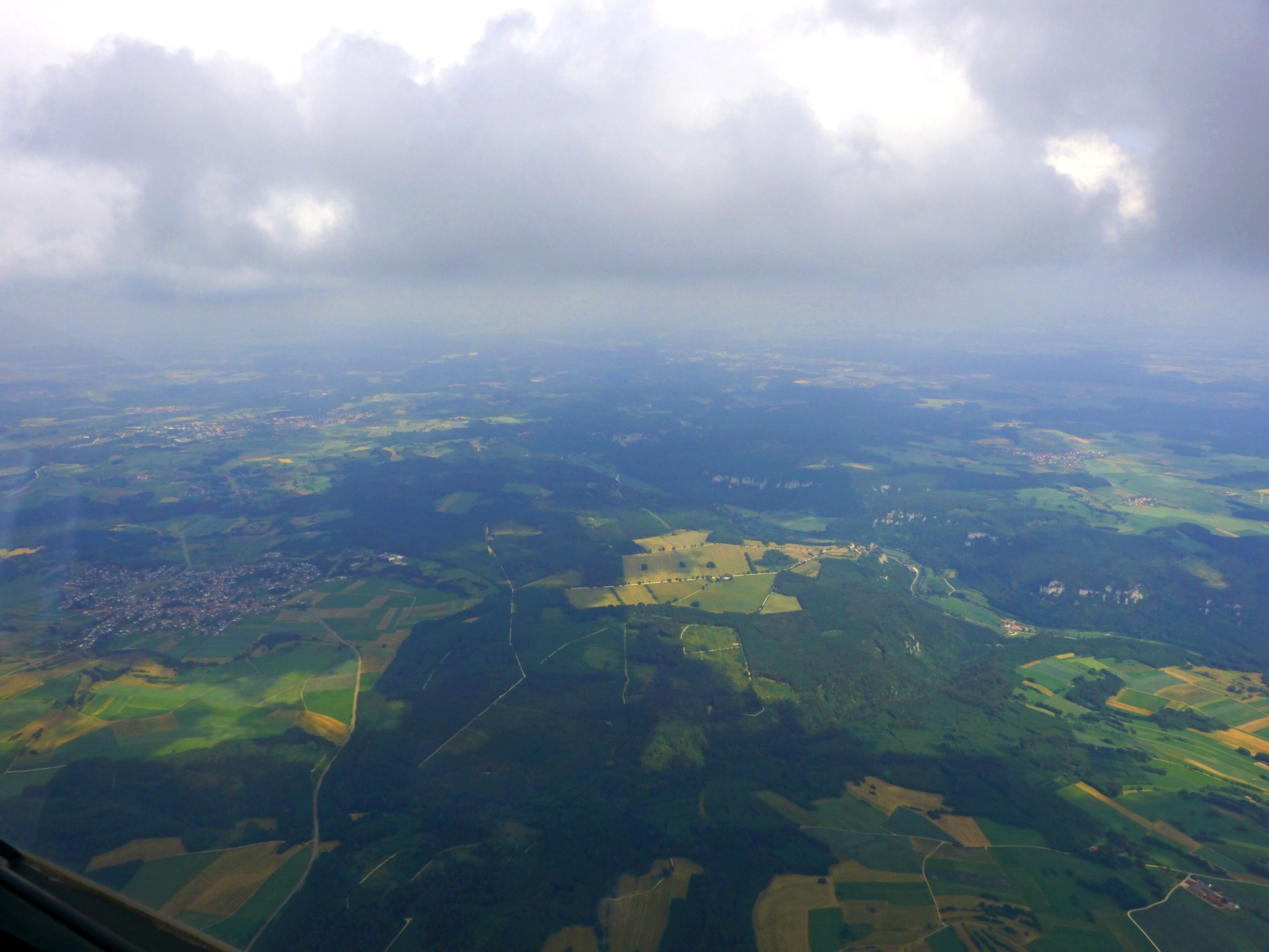 A landscape with fields, roads, and scattered buildings.