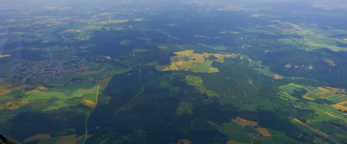 A landscape with fields, roads, and scattered buildings.