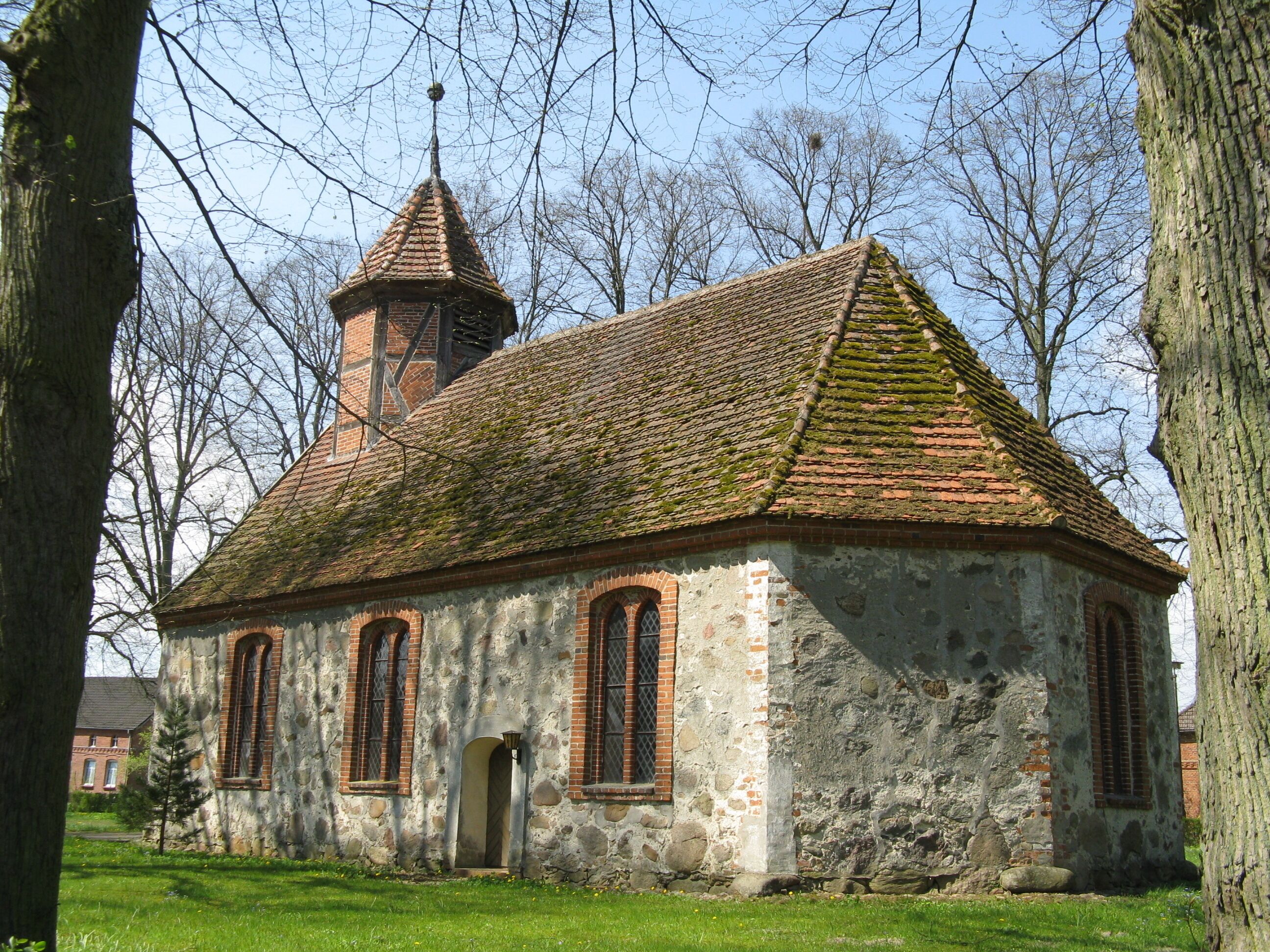A small, historic church with a steeply pitched roof and a bell tower.