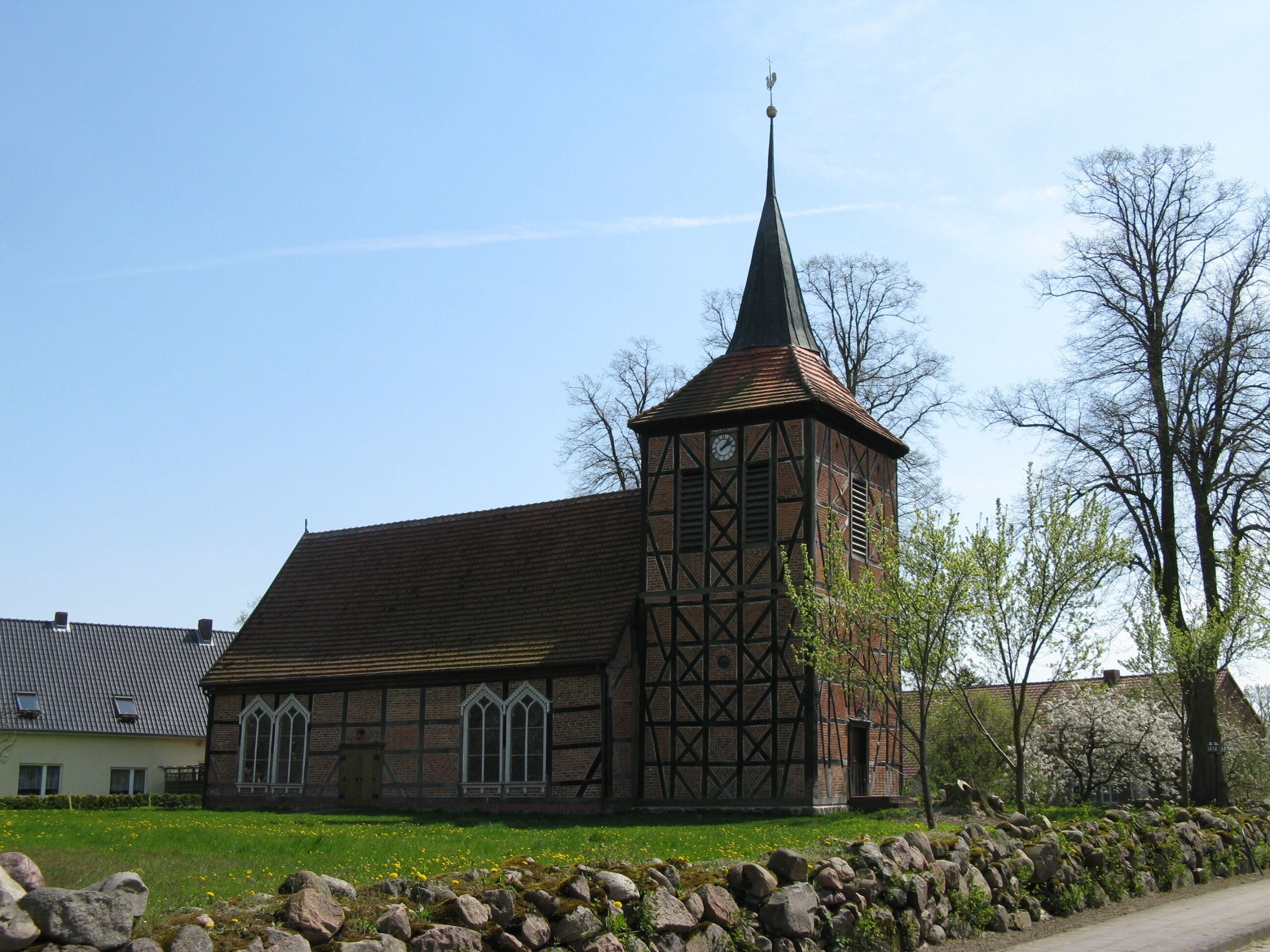 A church with a tall steeple and a clock tower.