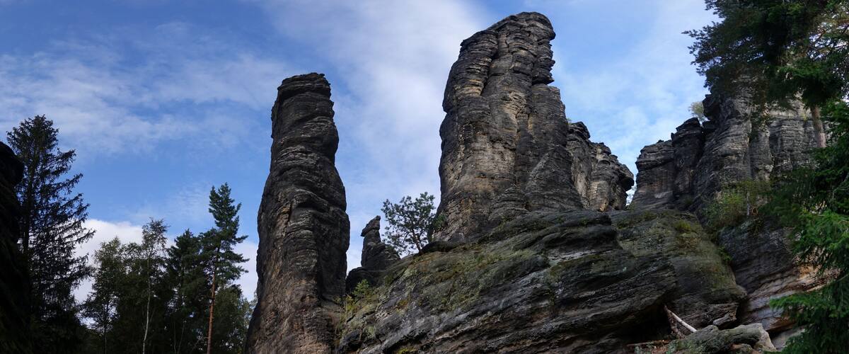 Towering rock formations amidst a forested landscape.