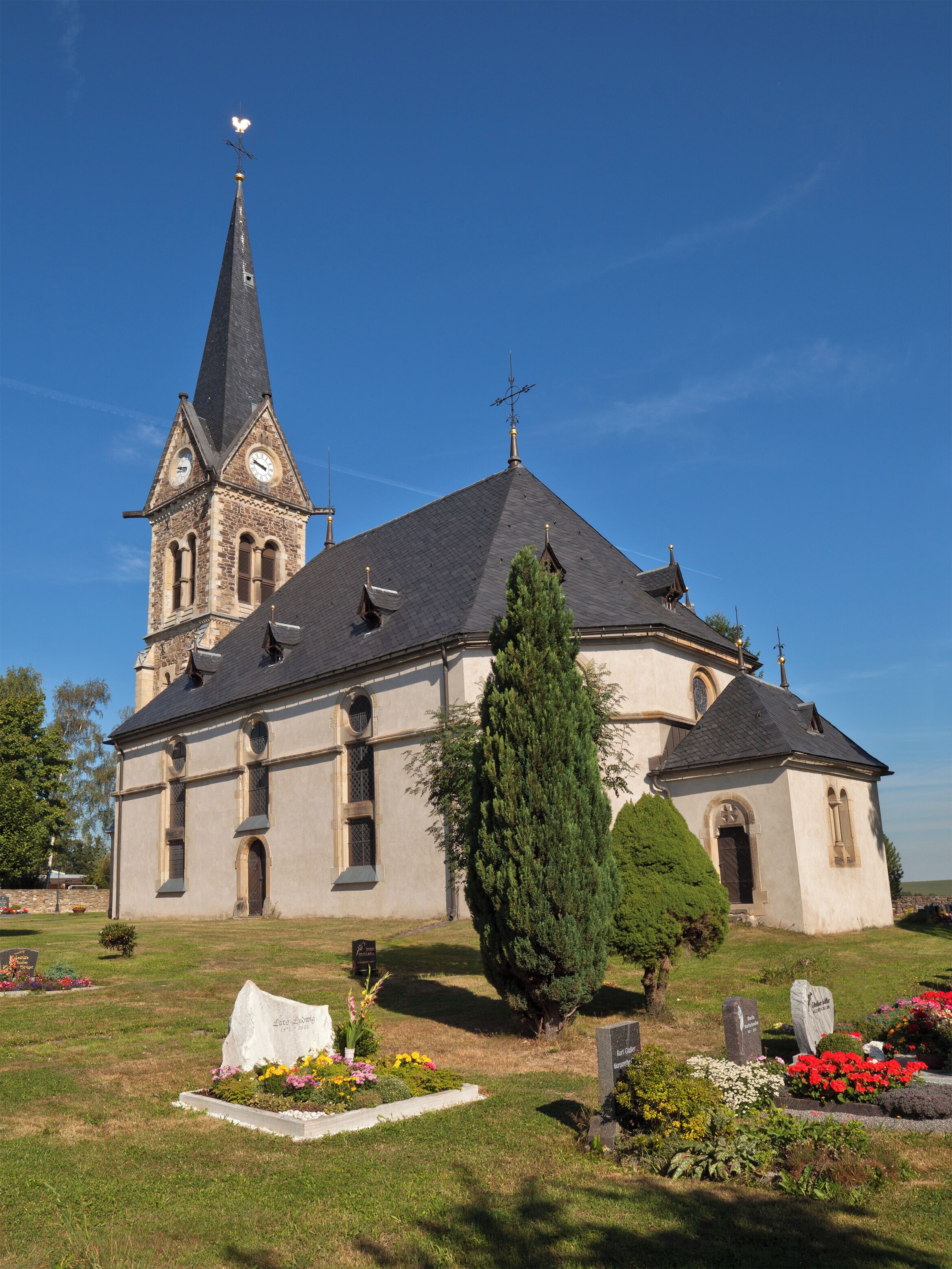 A church with a tall steeple and a clock tower.