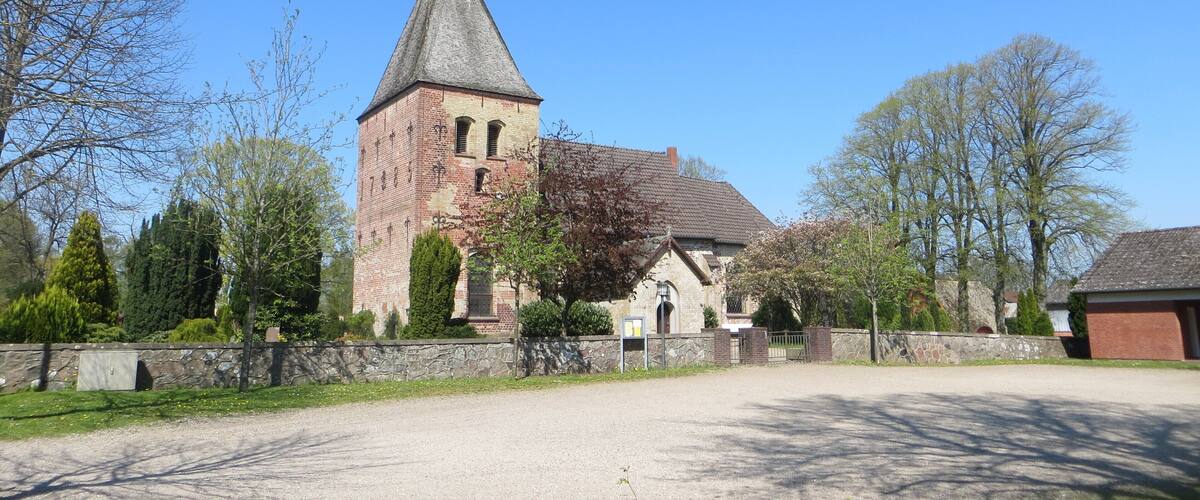 A church with a tall steeple and a brick tower.