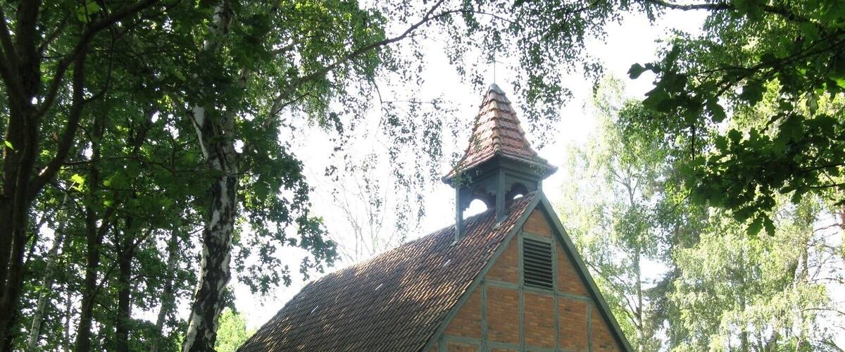 A traditional half-timbered building with a steeply pitched roof and a small tower.