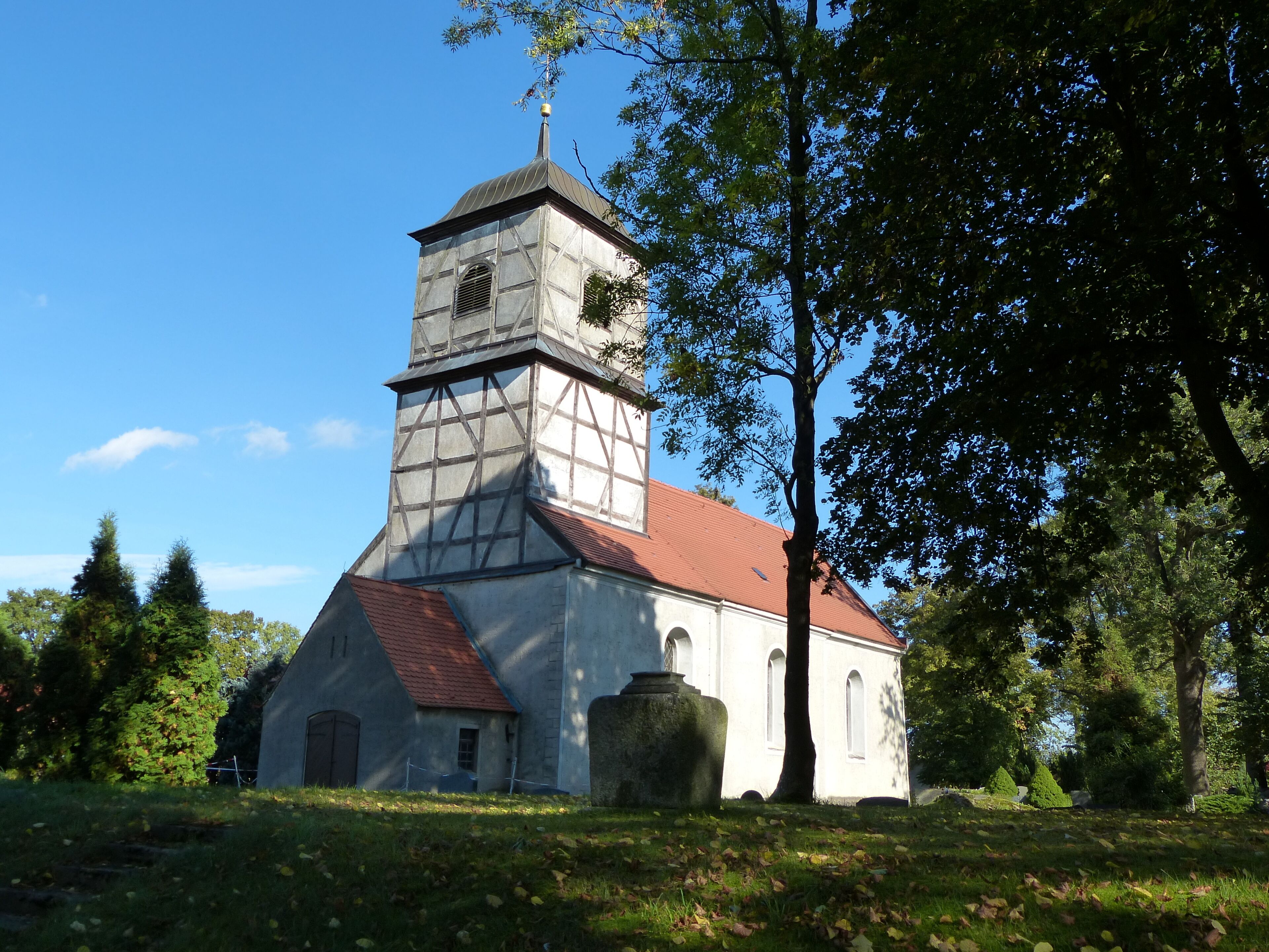 A church with a red roof and a tower.