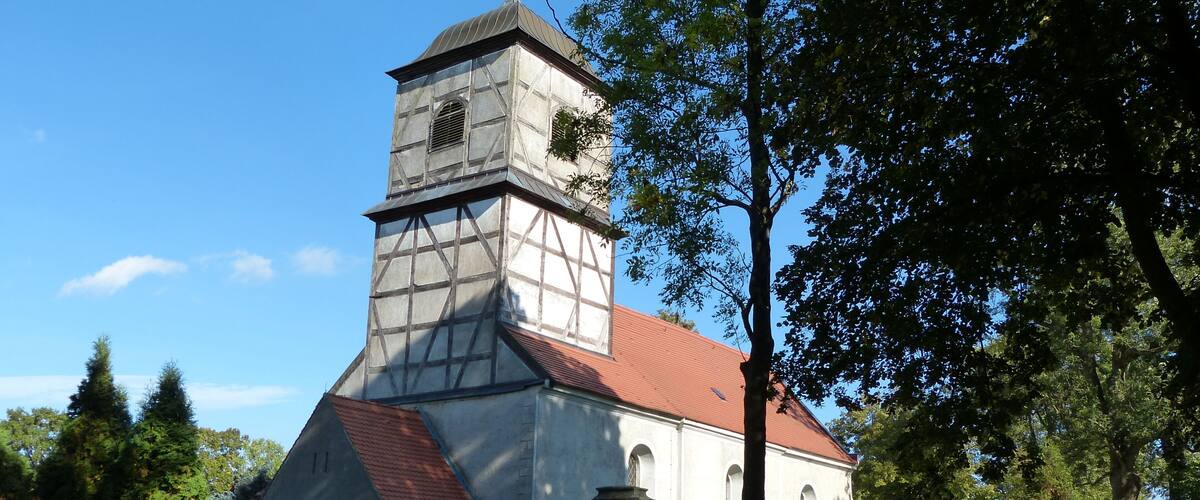 A church with a red roof and a tower.