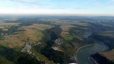 A river winding through a valley with fields and small settlements.