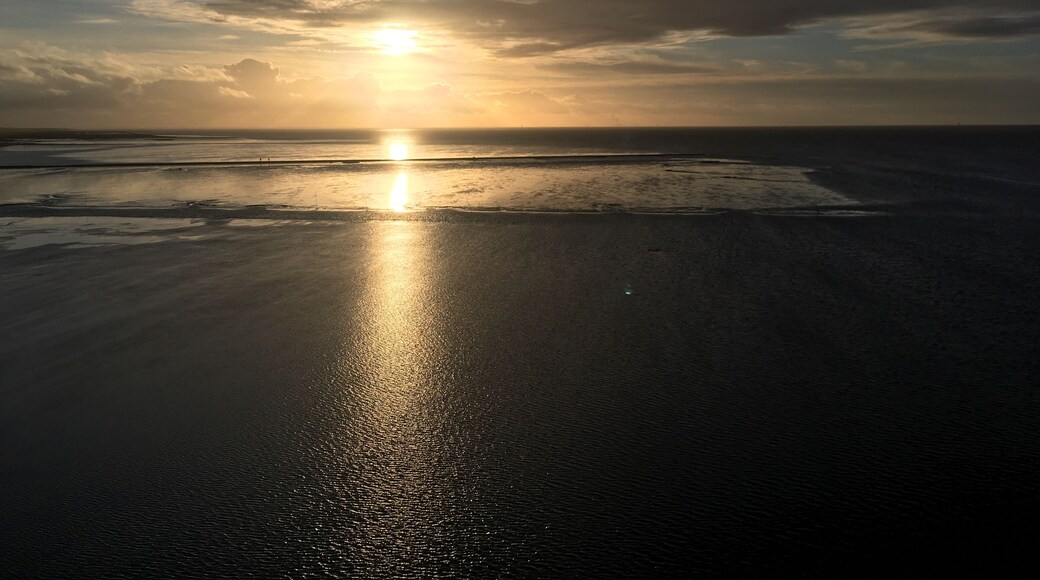 Beatiuful picture taken on the lighthouse in dorum showing the sun an the mud flat while an ebb.