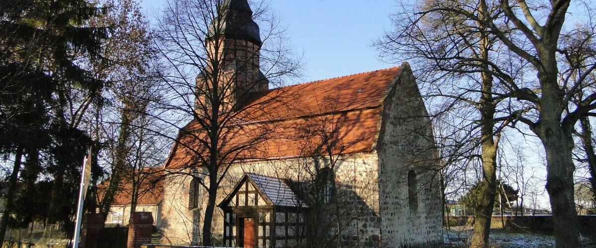 A church with a red roof and a tall steeple.