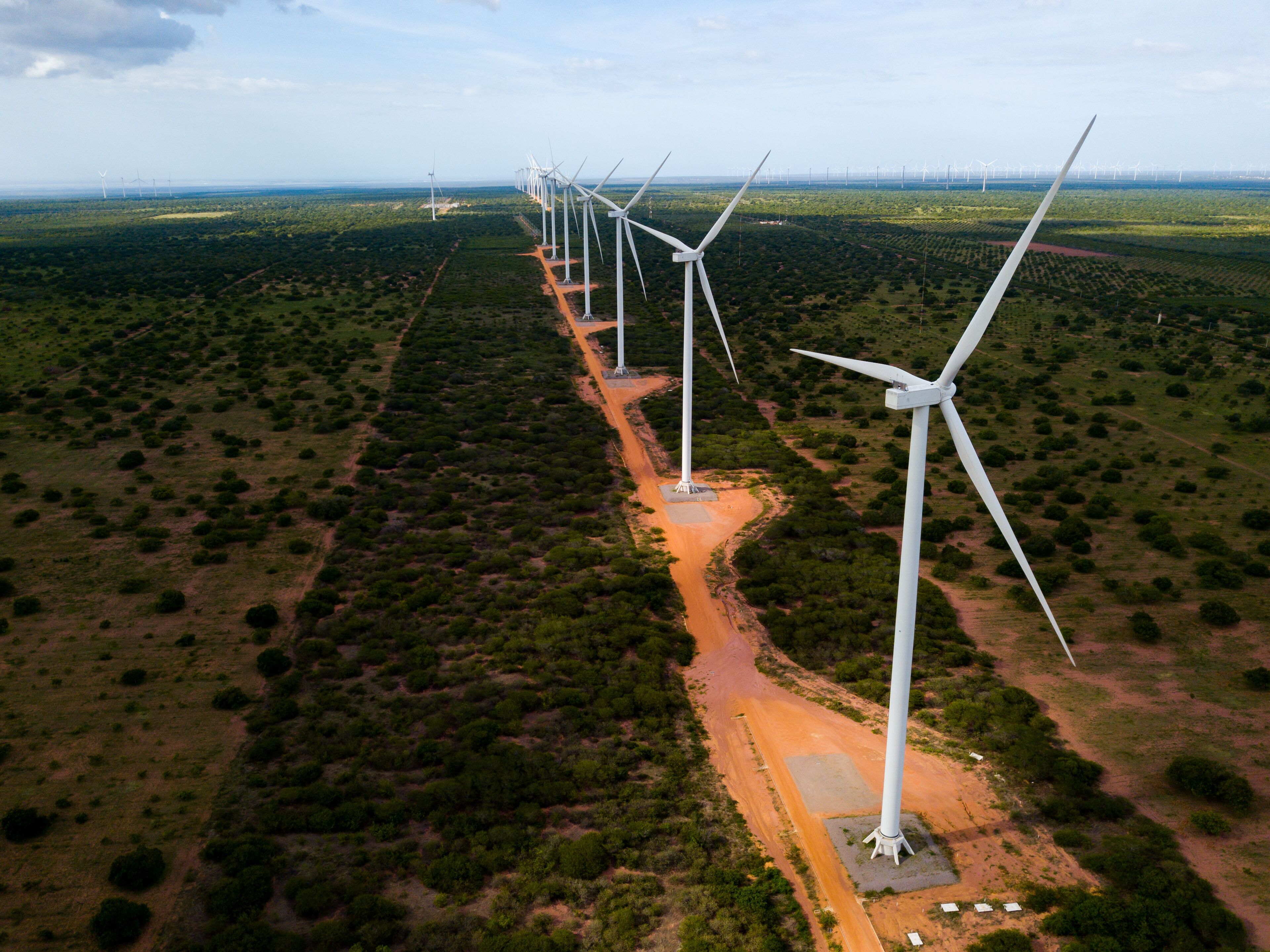 A wind farm with multiple wind turbines in a desert landscape.