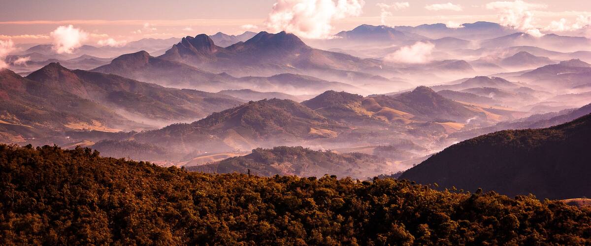 A mountainous landscape with rolling hills and dense forests.