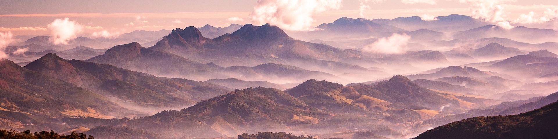 A mountainous landscape with rolling hills and dense forests.