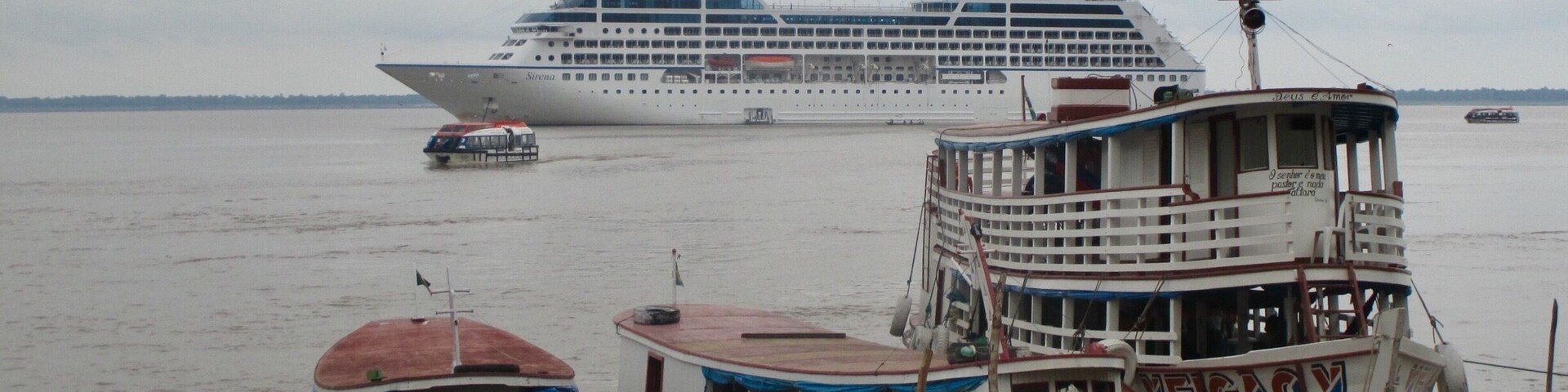 The river is used as a highway by the locals and you can see a wide variety of transportation options in the photo, including our home away from home.