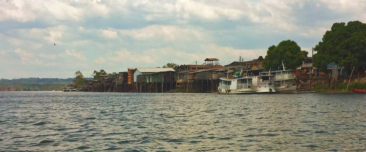 A river with boats and buildings along the shore.