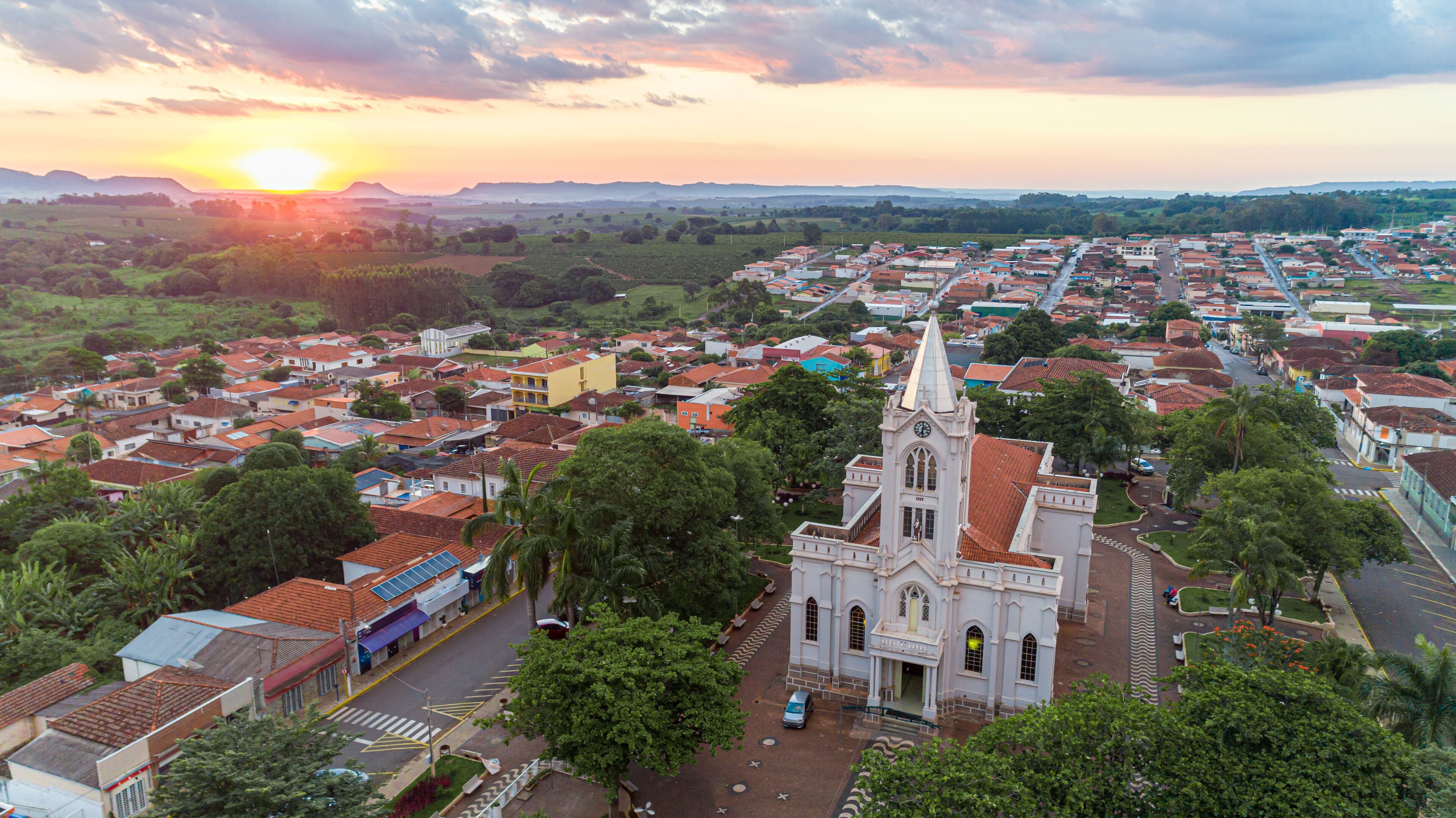 A town with a prominent church, surrounded by residential buildings and greenery.