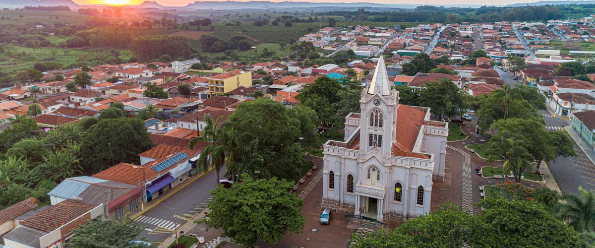 A town with a prominent church, surrounded by residential buildings and greenery.