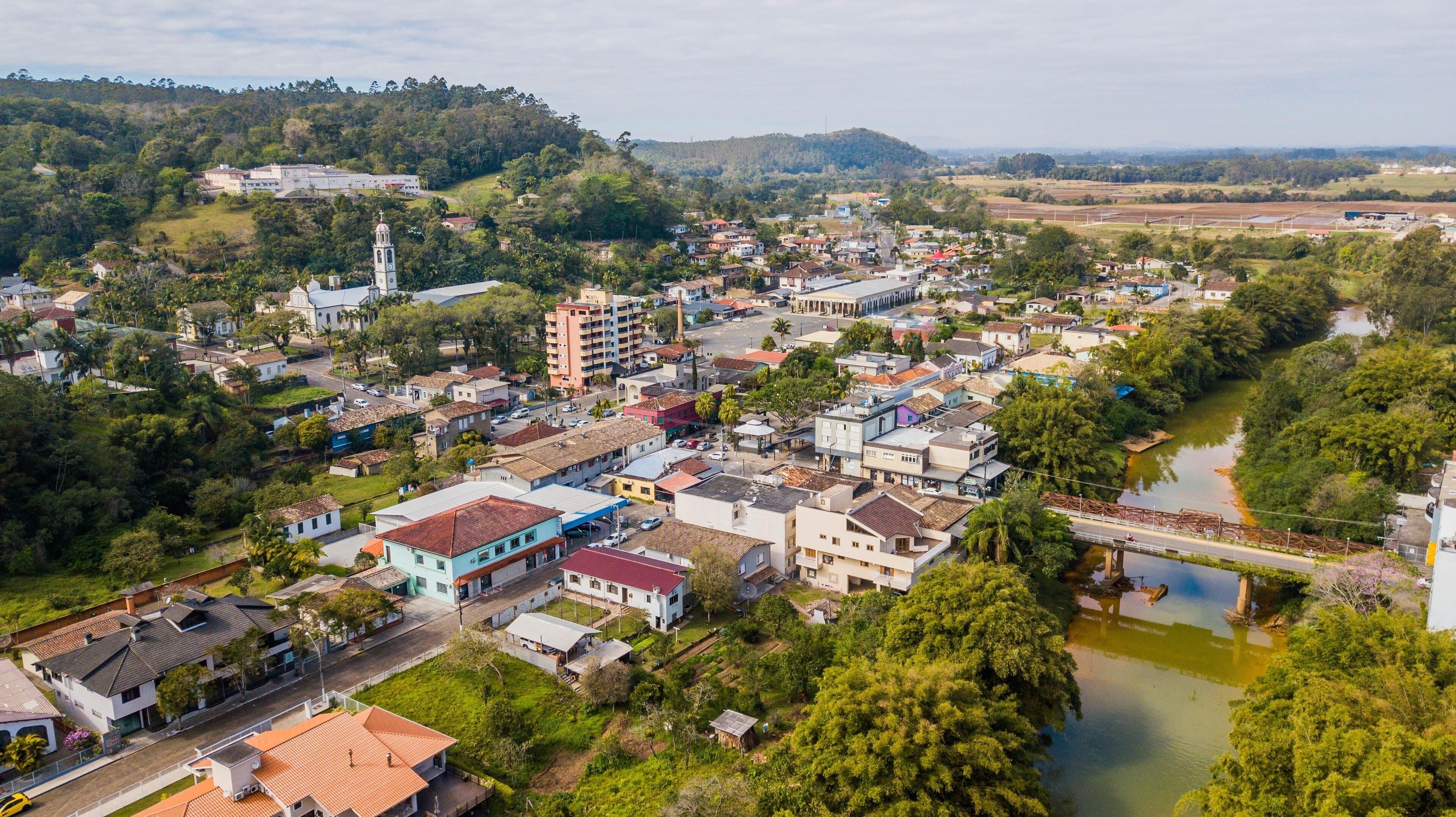 A town with a river, buildings, and a church.