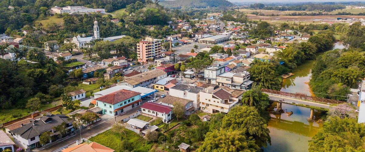 A town with a river, buildings, and a church.