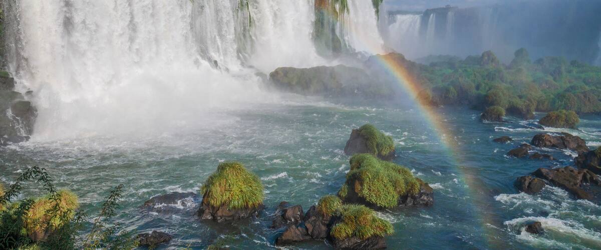 A large waterfall with a rainbow.