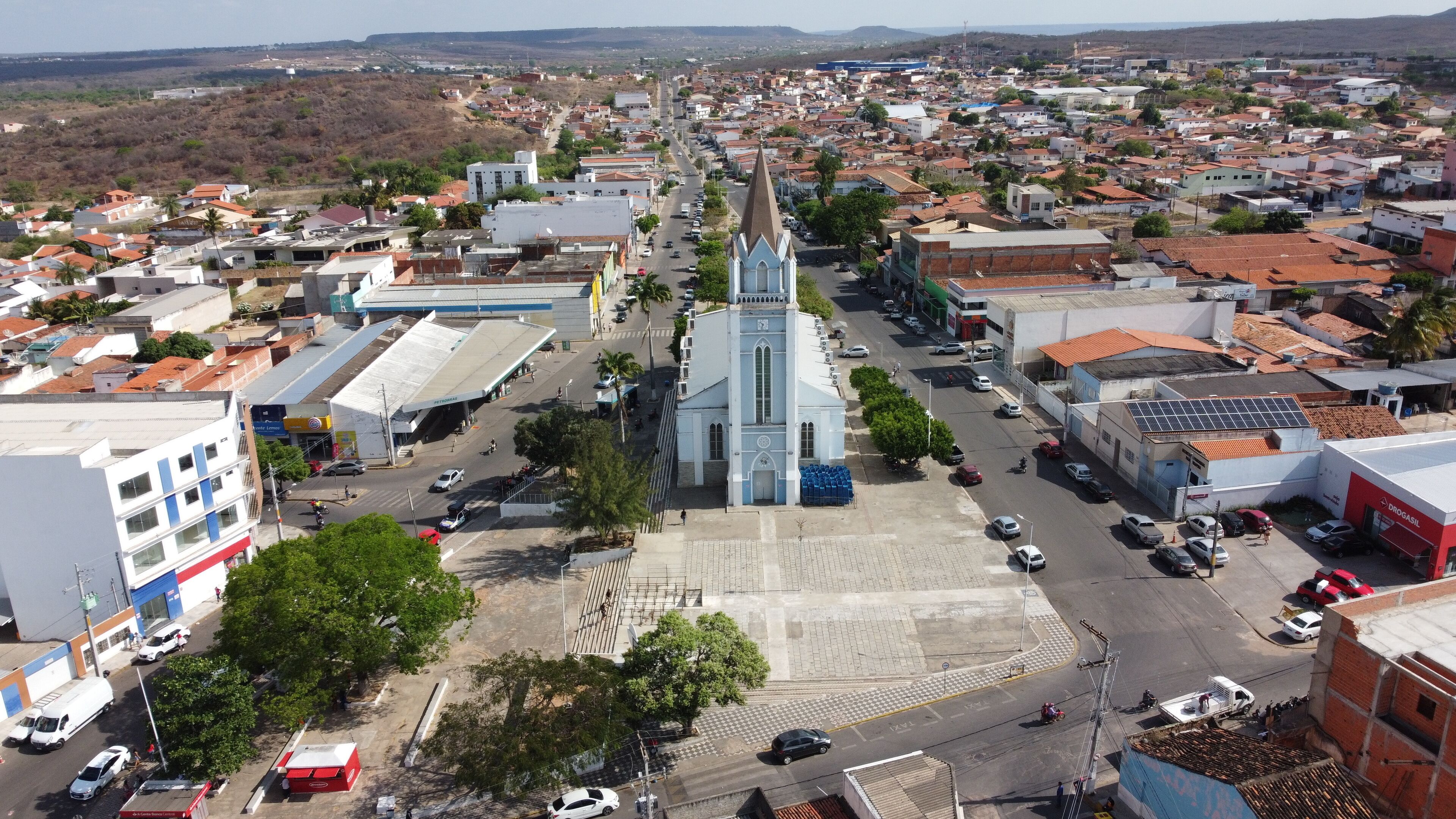 A town with a prominent church, a gas station, and a mix of residential and commercial buildings.