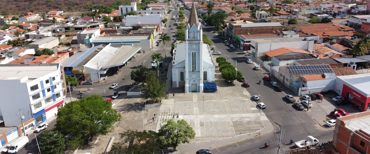 A town with a prominent church, a gas station, and a mix of residential and commercial buildings.