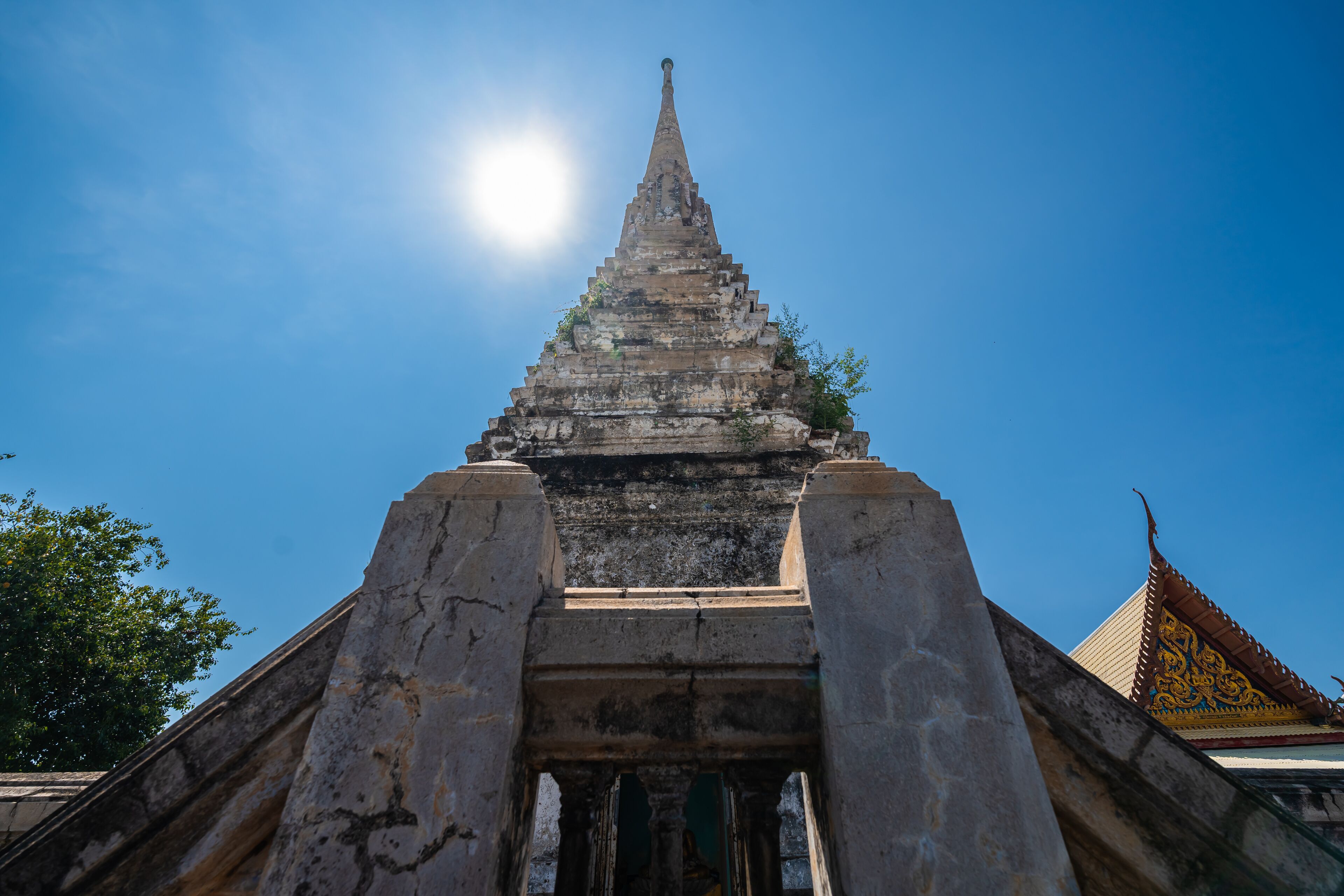 The old pagoda at Wat Klang Khlong Watthanaram, or Wat Muang, in Sena, Ayutthaya, is famed for its vibrant purple ordination hall and intricate decorations, making it a notable landmark in the area.