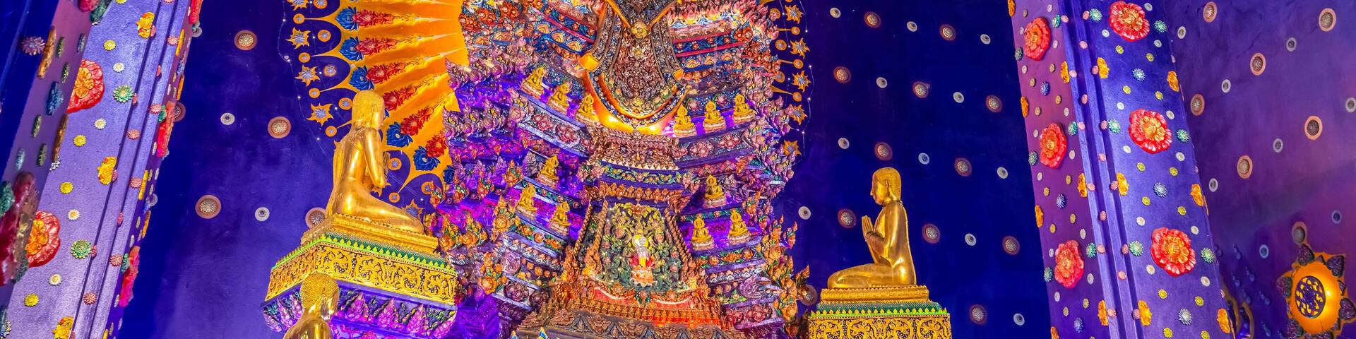 Wat Klang Khlong Watthanaram, or Wat Muang, in Sena, Ayutthaya, is famed for its vibrant purple ordination hall and intricate decorations, making it a notable landmark in the area.