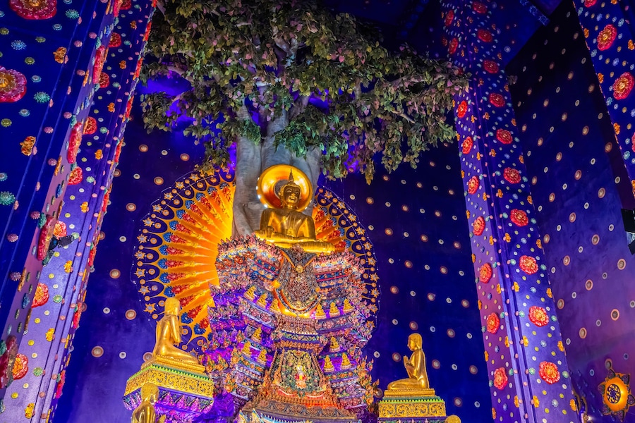 Wat Klang Khlong Watthanaram, or Wat Muang, in Sena, Ayutthaya, is famed for its vibrant purple ordination hall and intricate decorations, making it a notable landmark in the area.