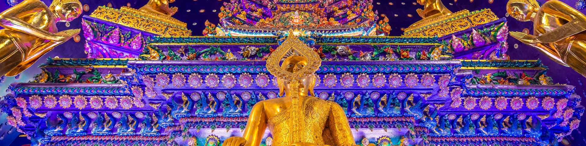 Wat Klang Khlong Watthanaram, or Wat Muang, in Sena, Ayutthaya, is famed for its vibrant purple ordination hall and intricate decorations, making it a notable landmark in the area.