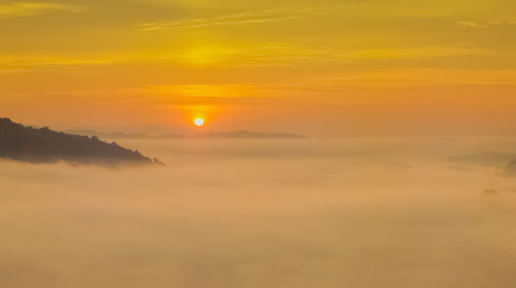 sunrise at Phu Huay Esan View Point, view of the hill around with sea of mist above Mekong river with yellow sun light in the sky background, Ban Muang, Sang Khom District, Nong Khai, Thailand.