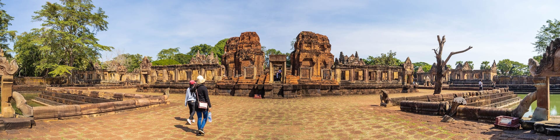 BURIRAM, THAILAND - December 4, 2021: Tourists visit the Khmer archaeological site of Prasat Muang Tam, Buriram Province, Thailand.
