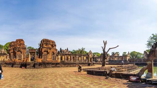 BURIRAM, THAILAND - December 4, 2021: Tourists visit the Khmer archaeological site of Prasat Muang Tam, Buriram Province, Thailand.