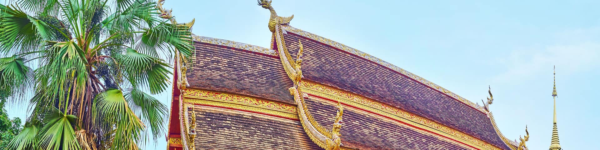 A golden temple with intricate designs and a tall spire.