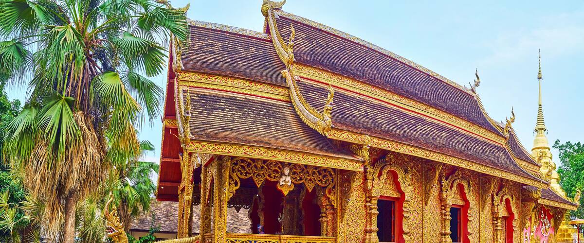 A golden temple with intricate designs and a tall spire.