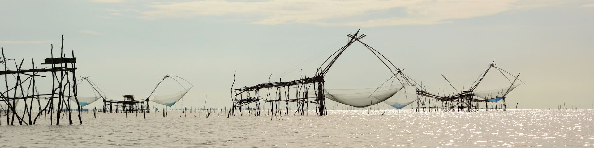 Fishing nets silhouettes at Thale Luang. Upper Songkhla lake. Phatthalung province. Thailand