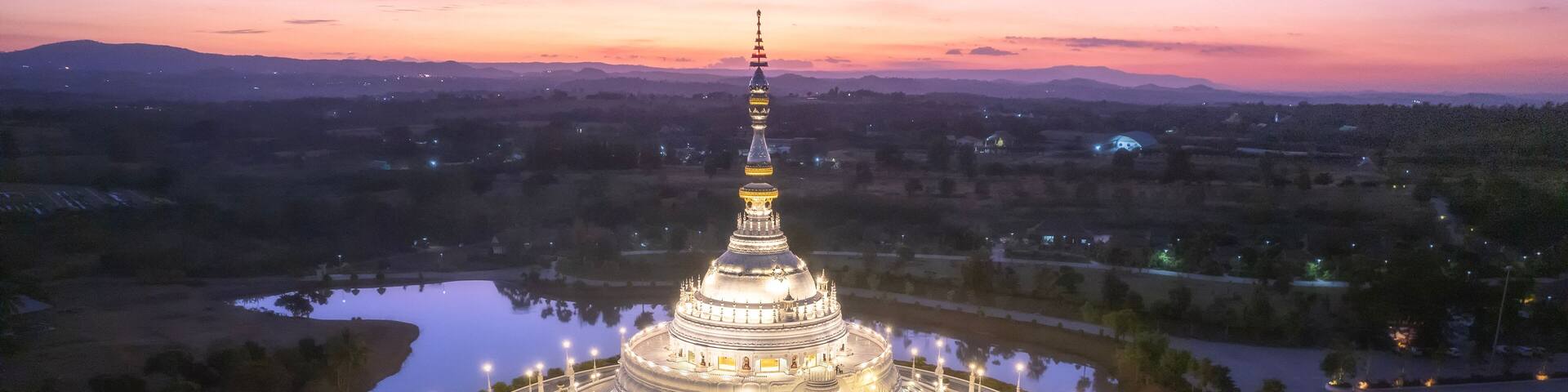 Beautiful Aerial view White Pagoda at Wat Sangtham in sunset time at Wang Nam Khiao District, Nakhon Ratchasima Thailand.