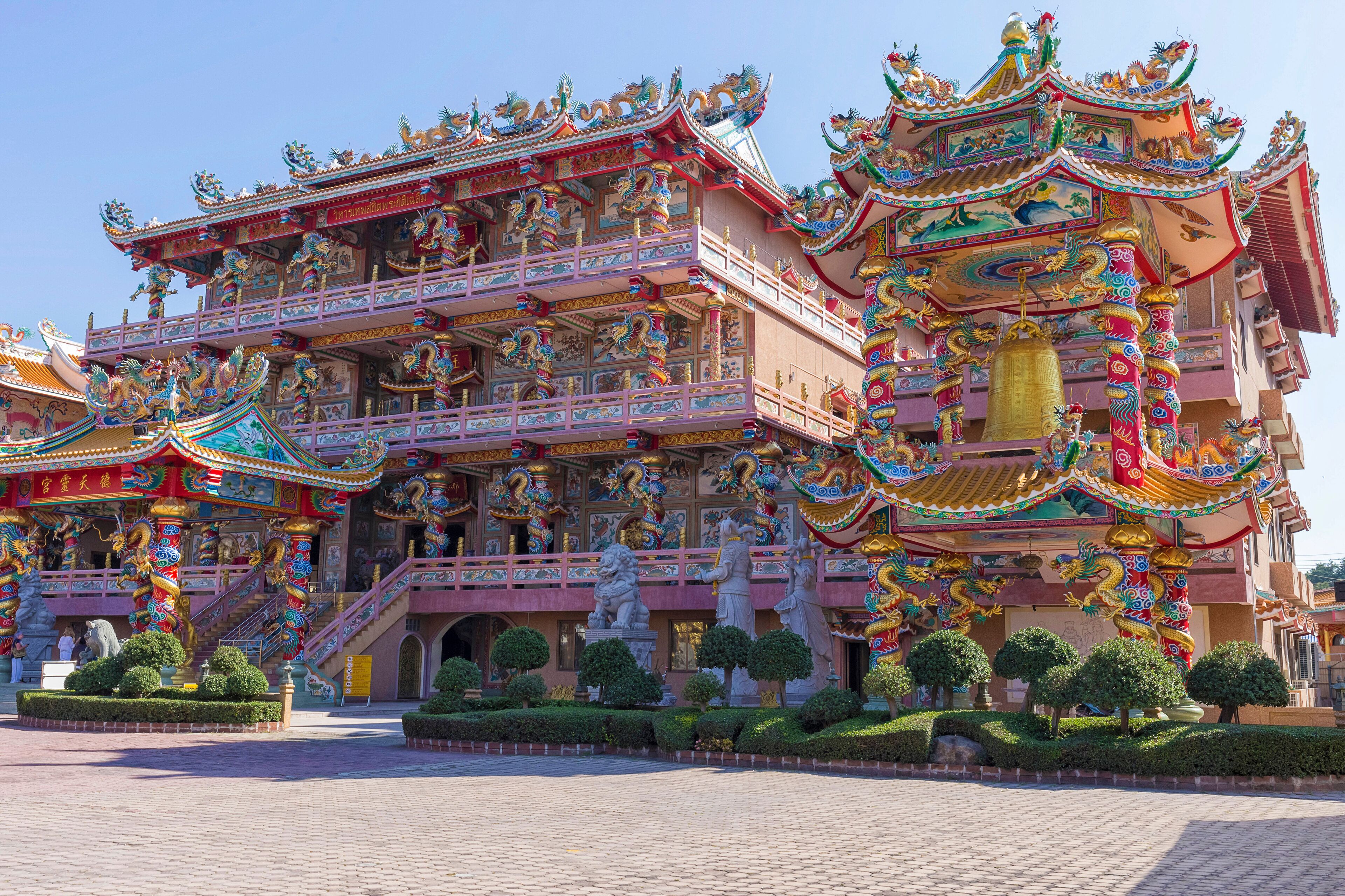 A multi-tiered temple with ornate decorations and statues.