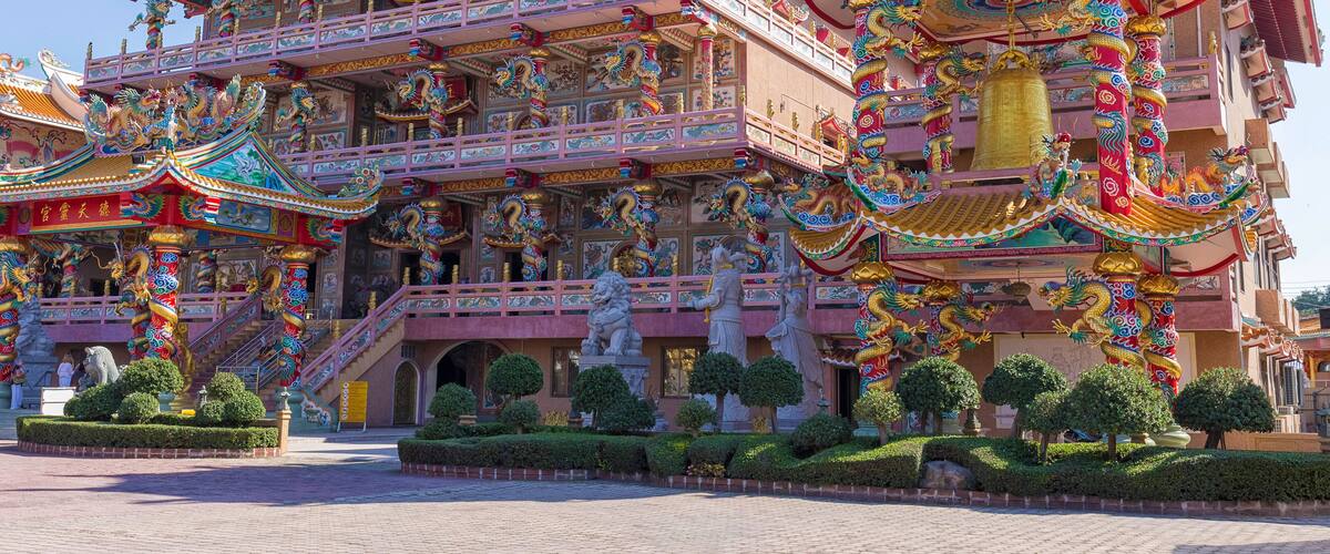 A multi-tiered temple with ornate decorations and statues.