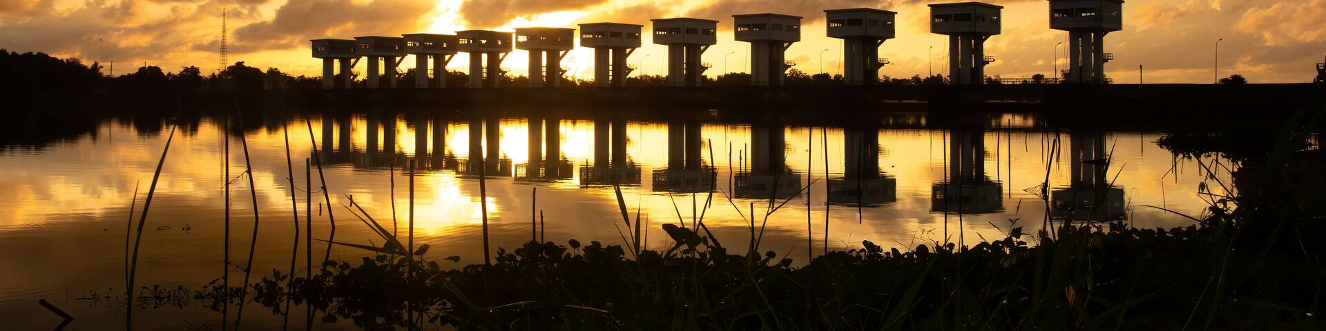 Silhouette and sunrise "Uthokvibhajaprasid" barrage in Pak Phanang. Thailand
